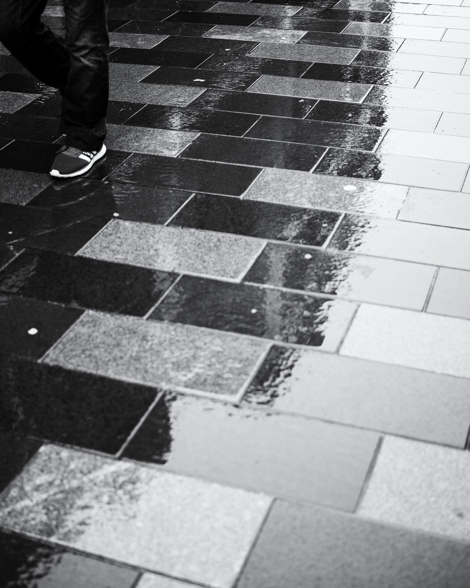 A person's feet in the rain